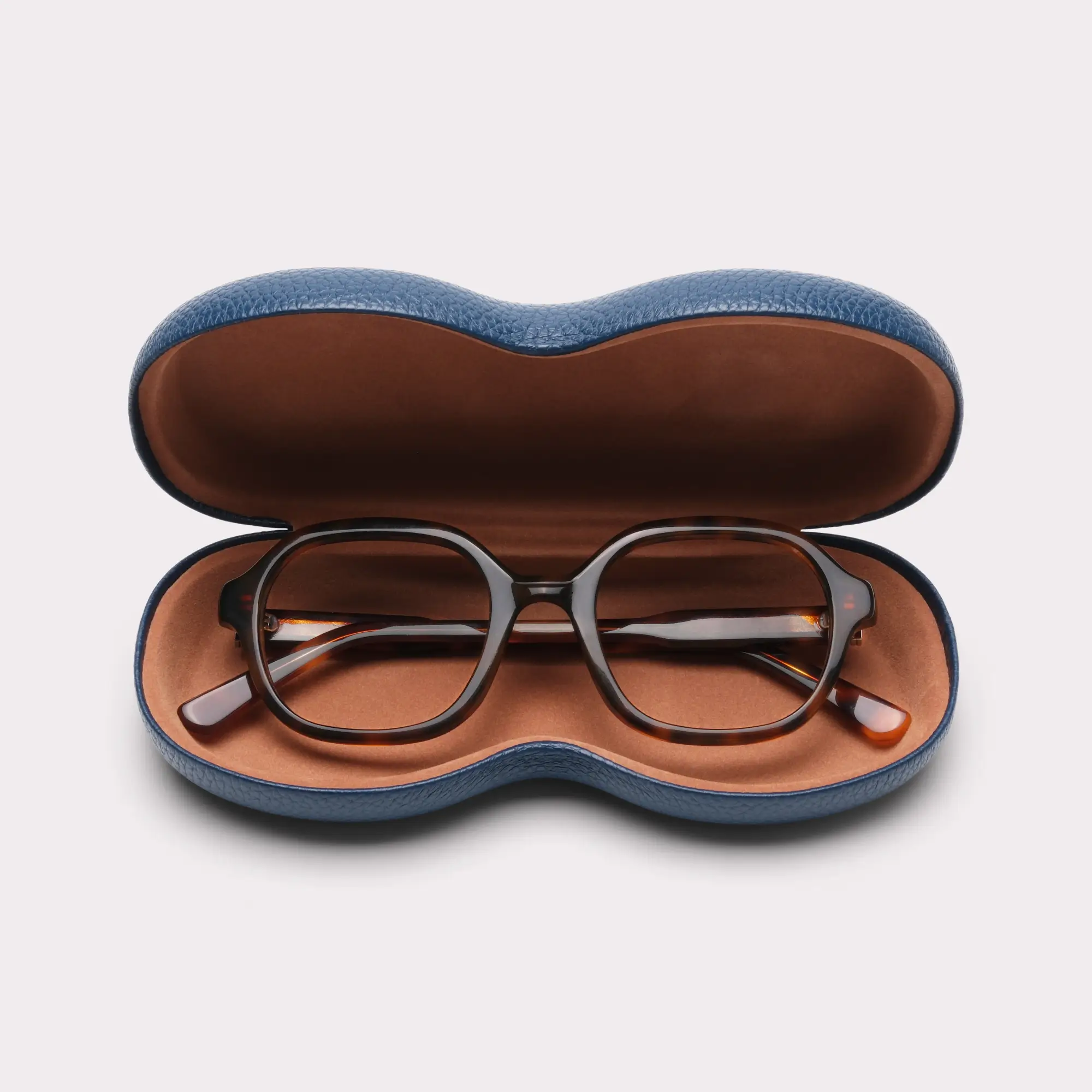 A pair of Lana Tortoise Reading glasses coming out of its case
