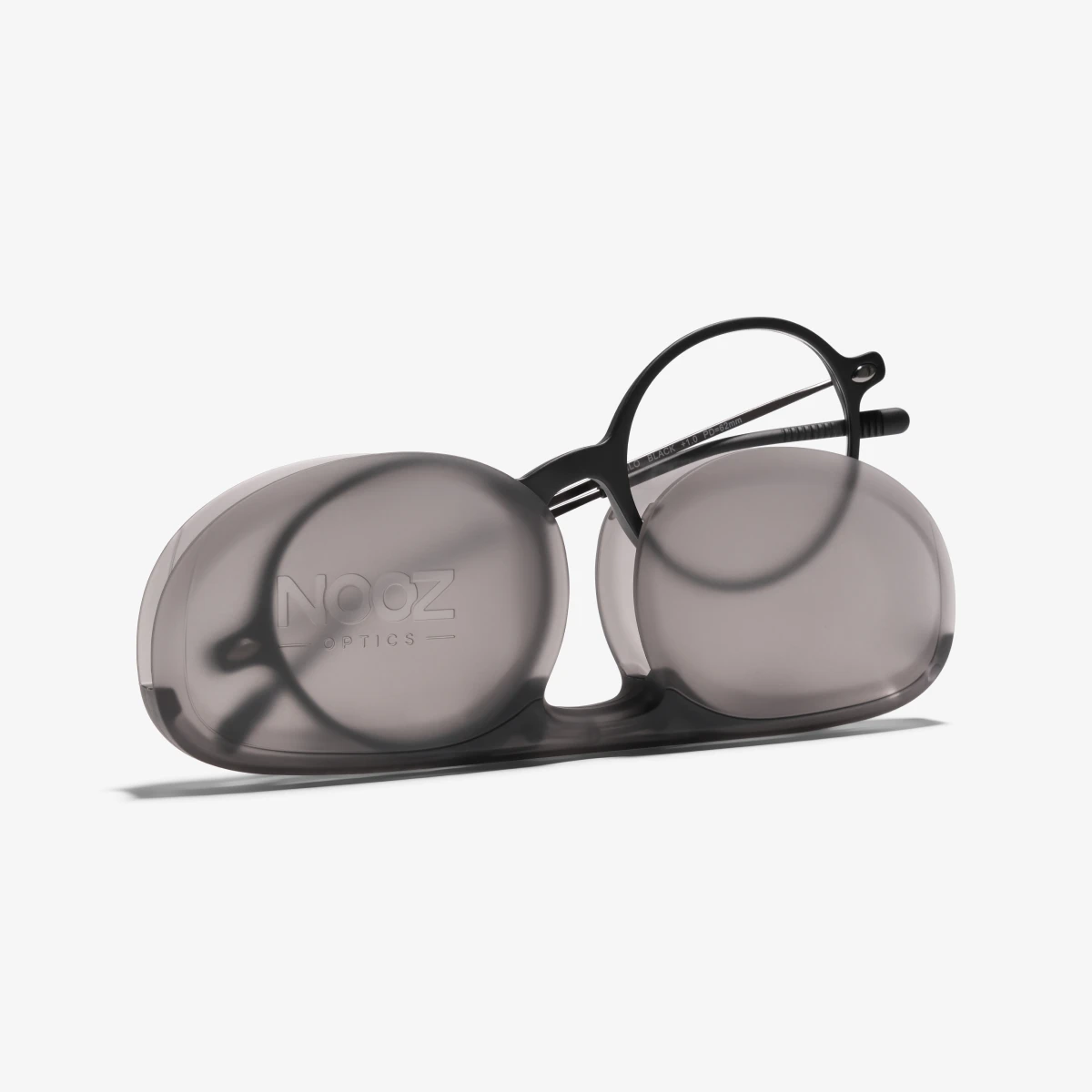 A pair of black Milo reading glasses coming out of its case