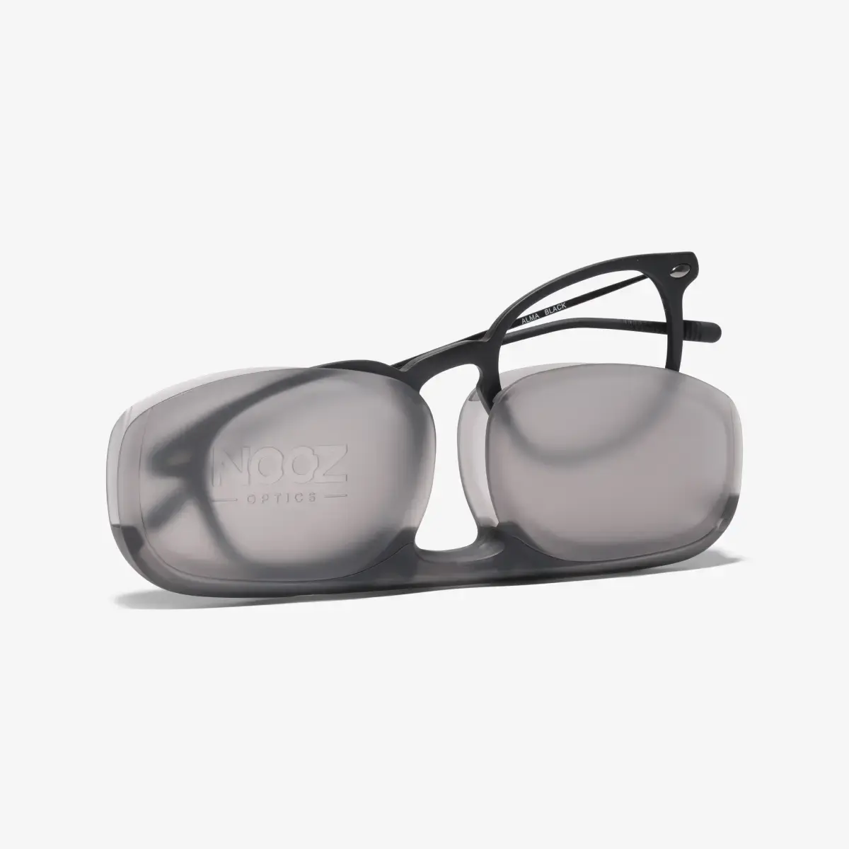 A pair of black Alma reading glasses coming out of its case