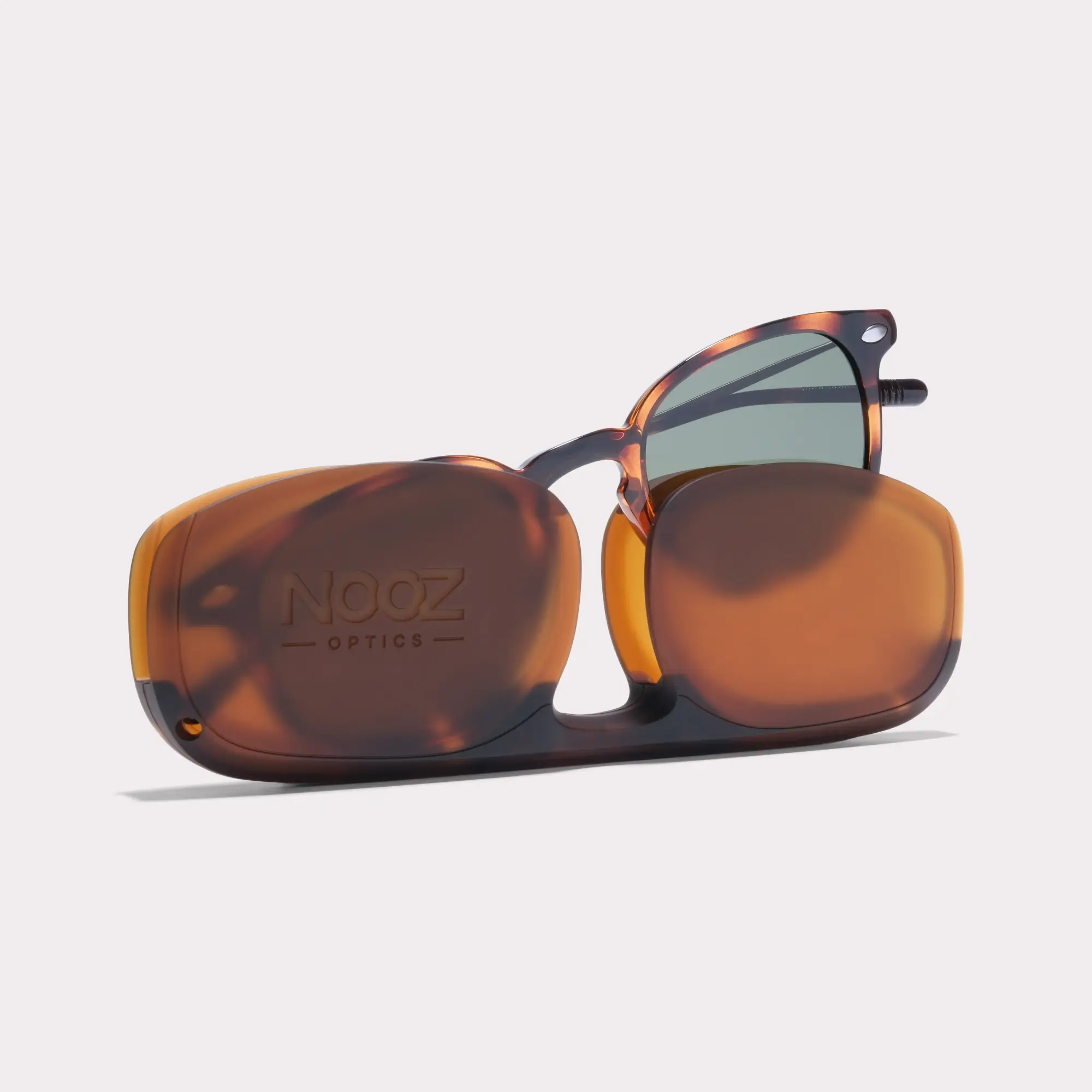 Une paire de Alma Tortoise Lunettes de soleil sortant de son étui