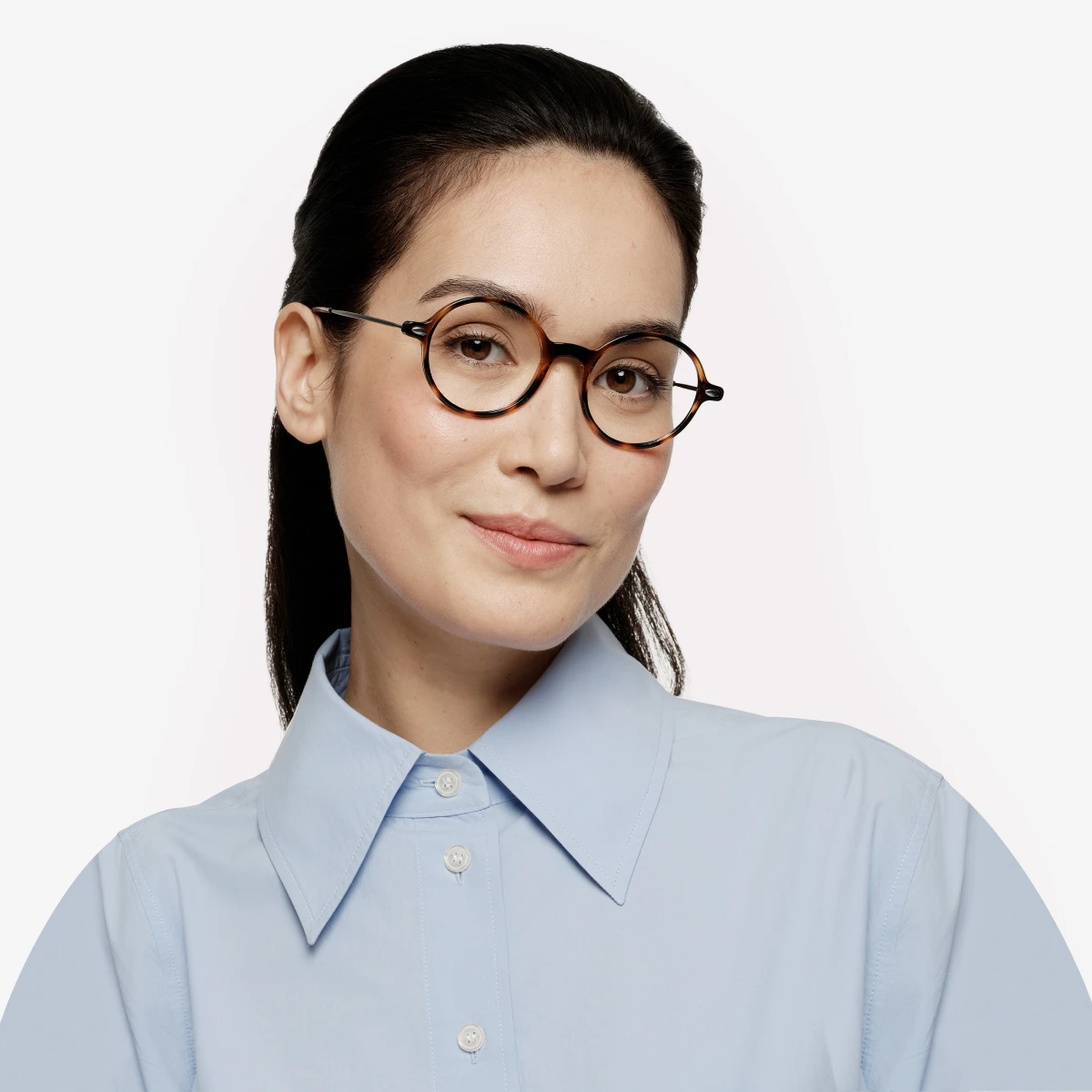 A woman wearing our tortoise Milo glasses