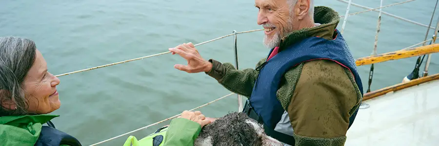 Kvinna, man och hund på en båt.