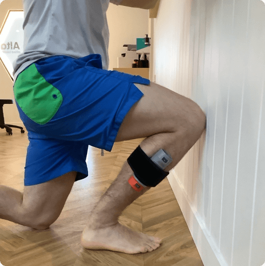 Athlete performing a Half Kneeling Knee to Wall range of motion test using DynaMo Plus