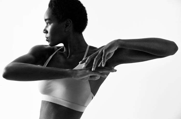 Mirror-Interactive-Gym-Black-And-White-Woman-Stretching-Lifestyle-Photo