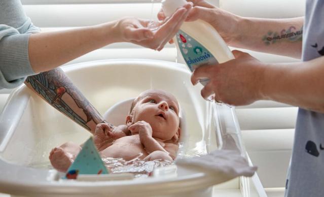 Bathing newborn with Johnson's® CottonTouch™ newborn wash & shampoo