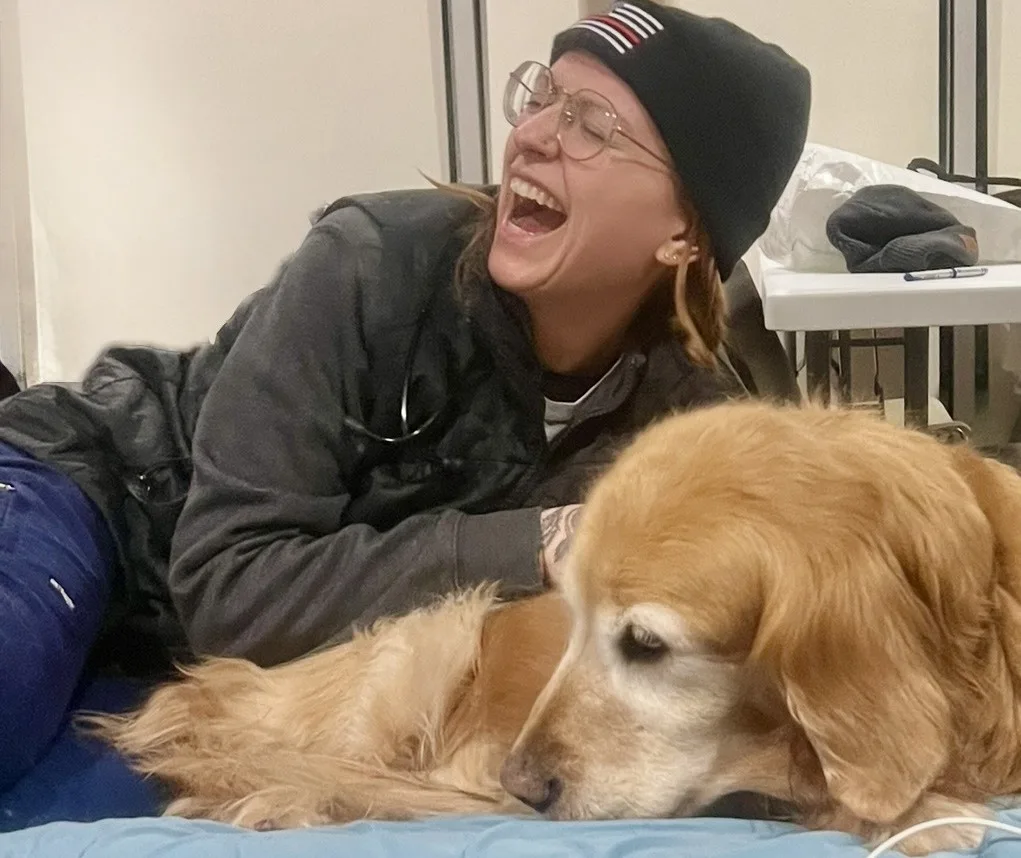 technician laughing with dog