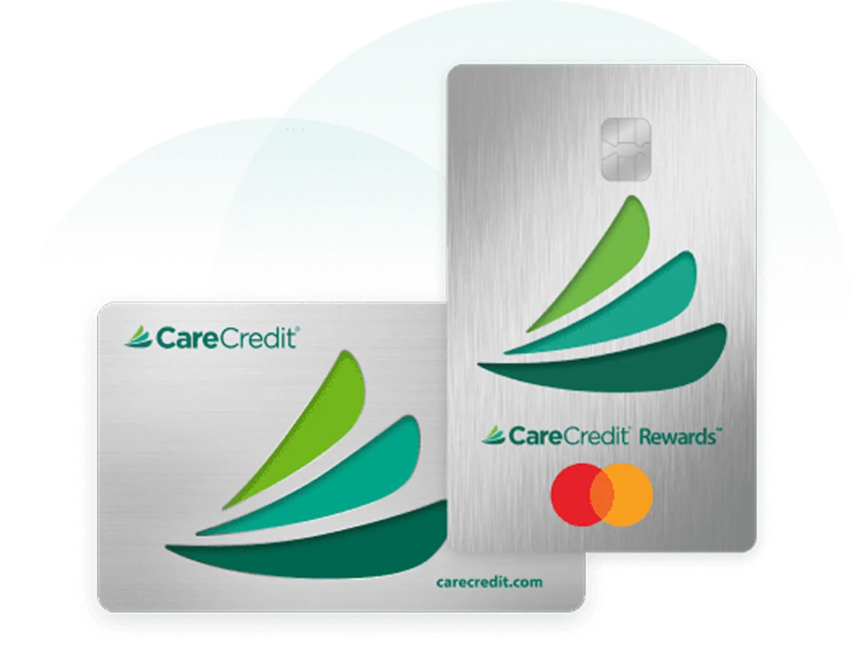 Two silver CareCredit cards: a horizontal standard card and a vertical Rewards Mastercard, both featuring a three-tiered green leaf logo.