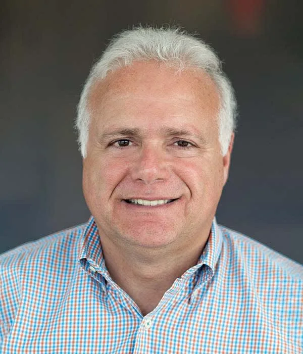 The Official headshot of Gino Volpacchio the Founder & Vice Chair.