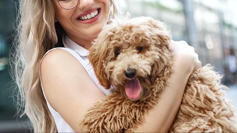 Happy lady holding dog