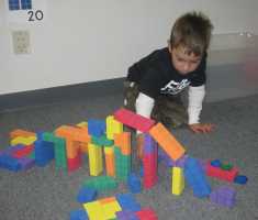 Boy building bridge out of number blocks