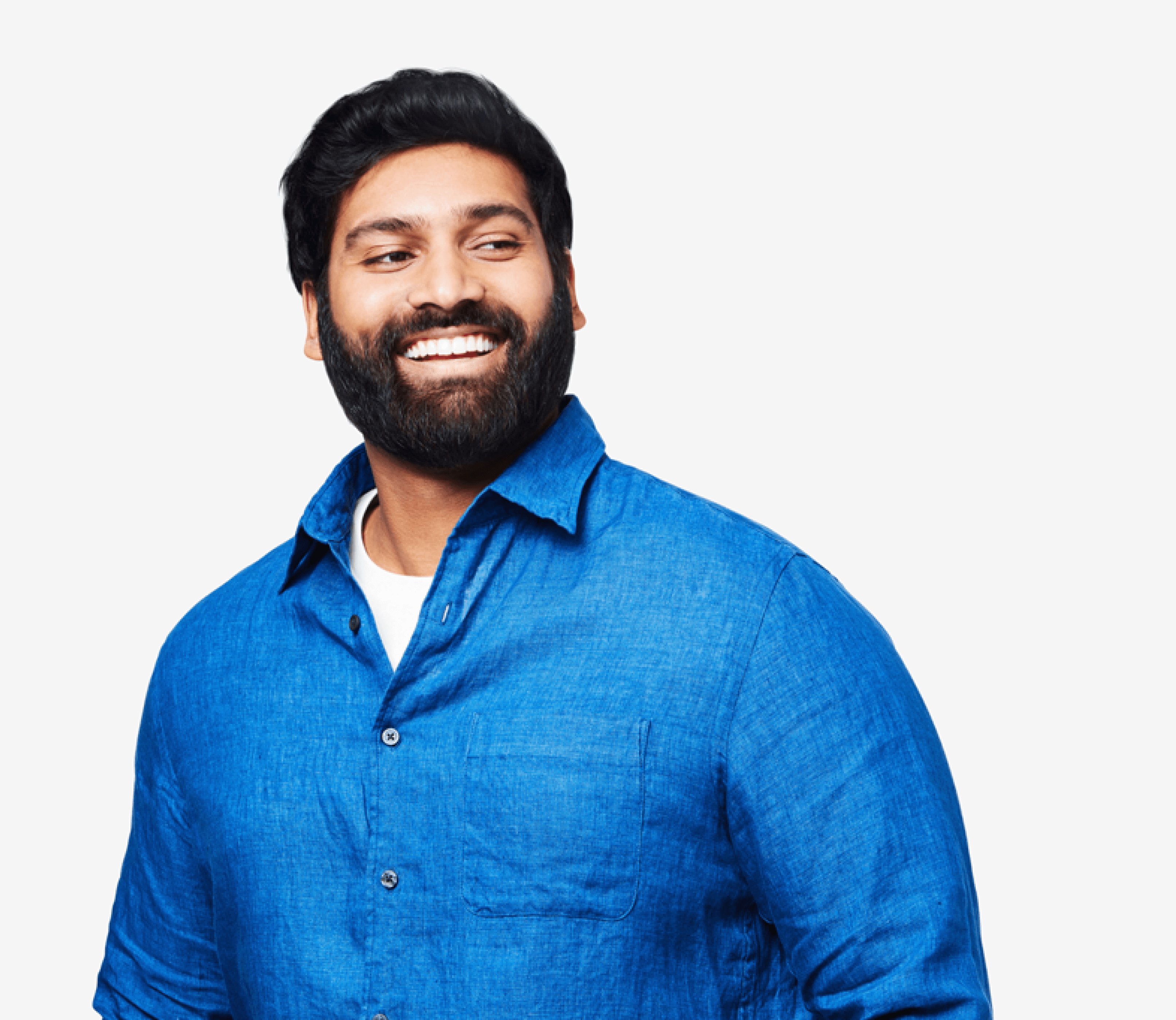 Smiling black haired man with beard and blue shirt looking to his left