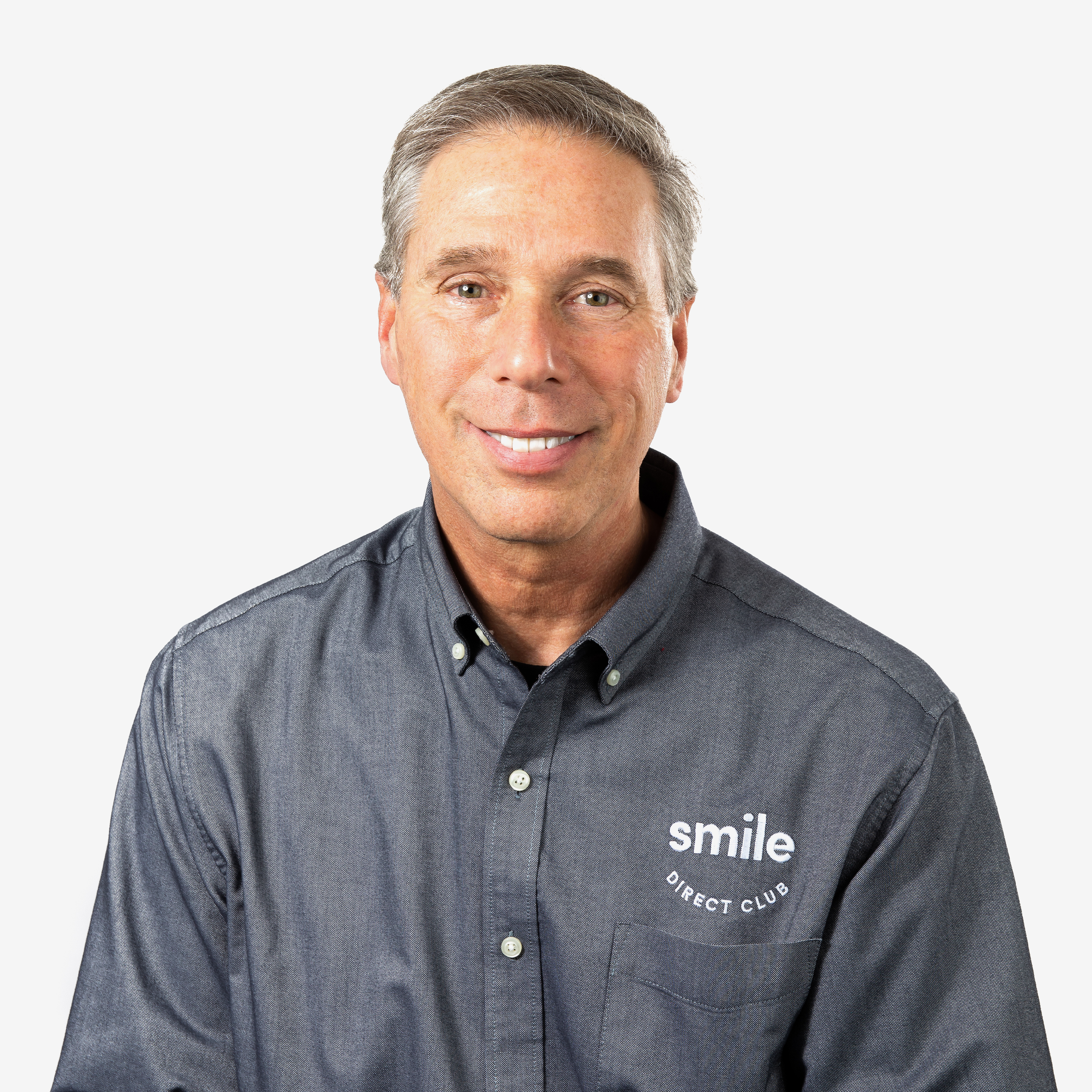 Dr. Jeffrey Sulitzer smiling and wearing a gray SmileDirectClub branded t-shirt headshot