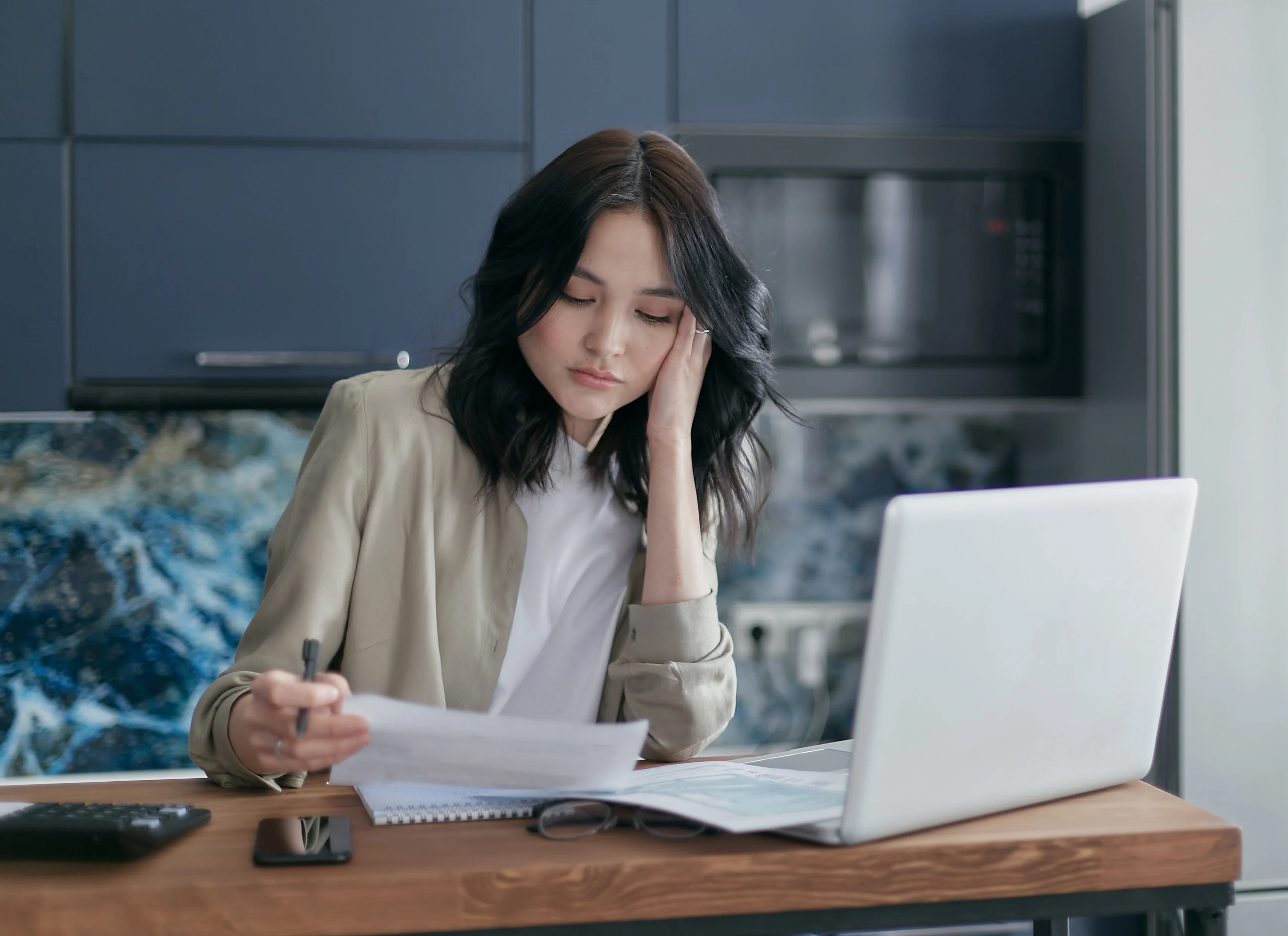 A Woman Holding a Pen and Paper