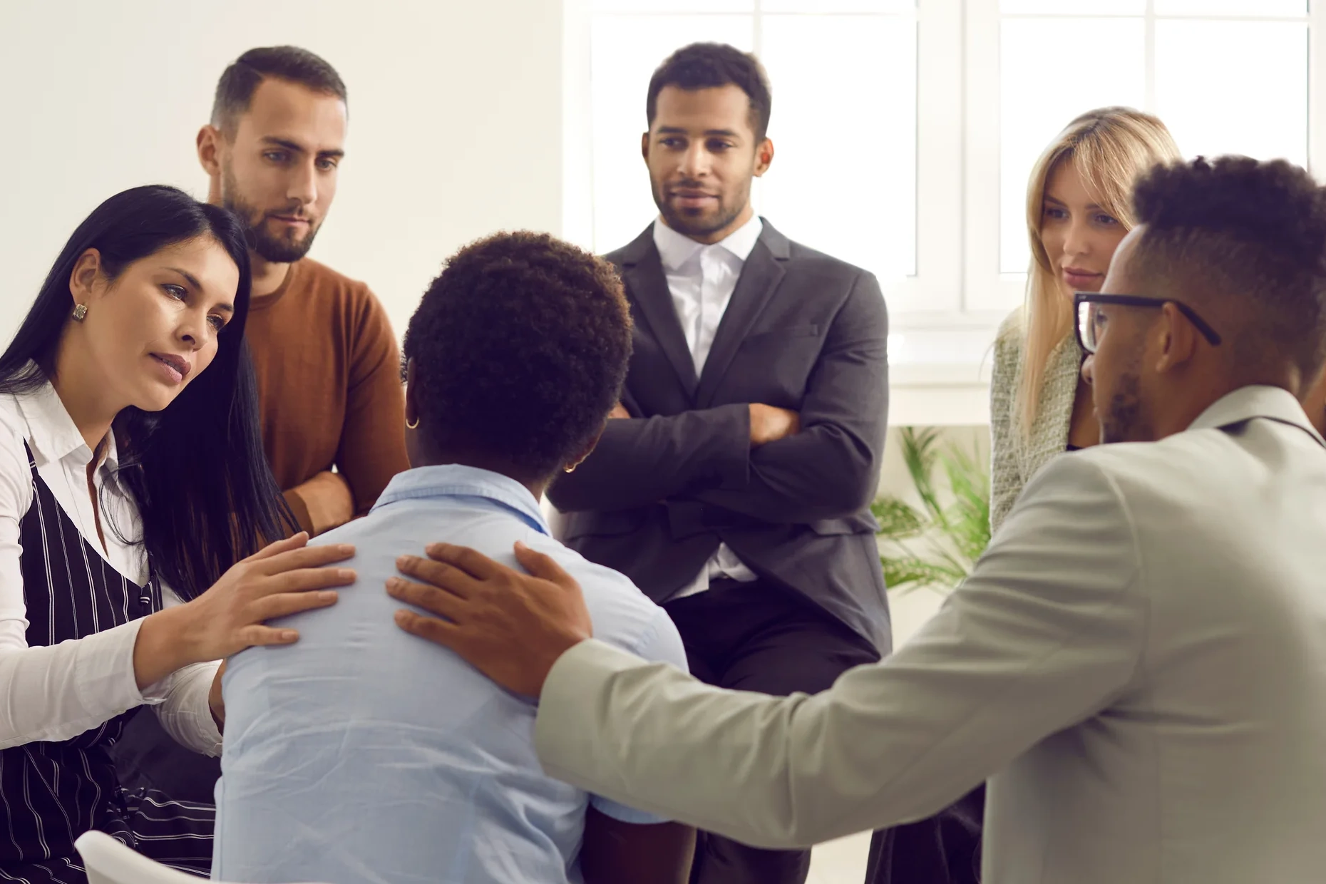 A group of people are comforting woman