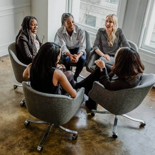 Women sitting in the office chairs and are in the middle of discussion