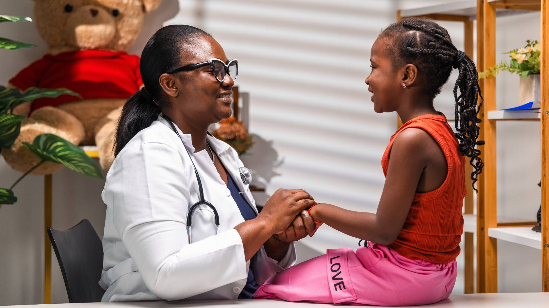Family doctor is holding a kids hand