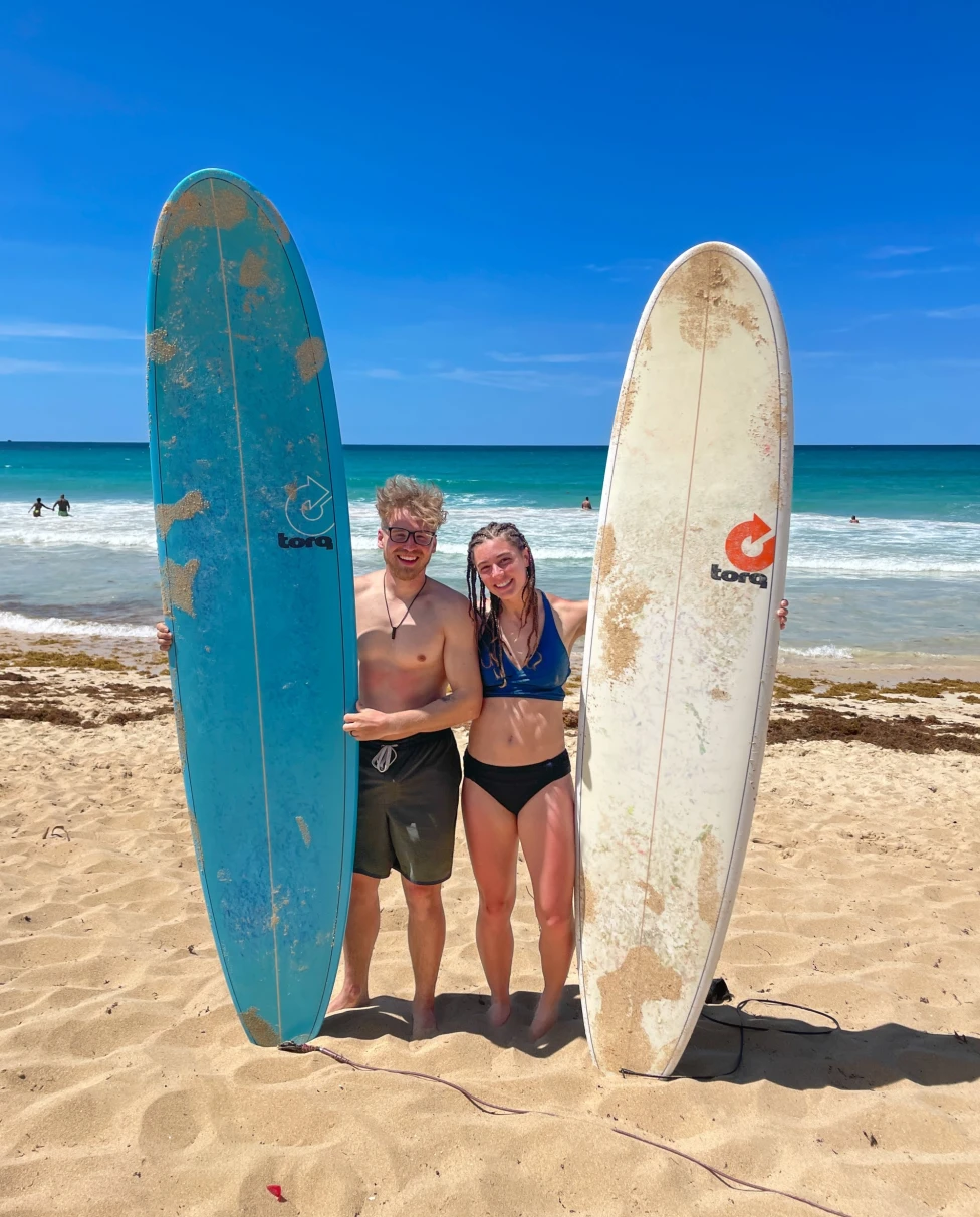 Couple posing with surfing boards