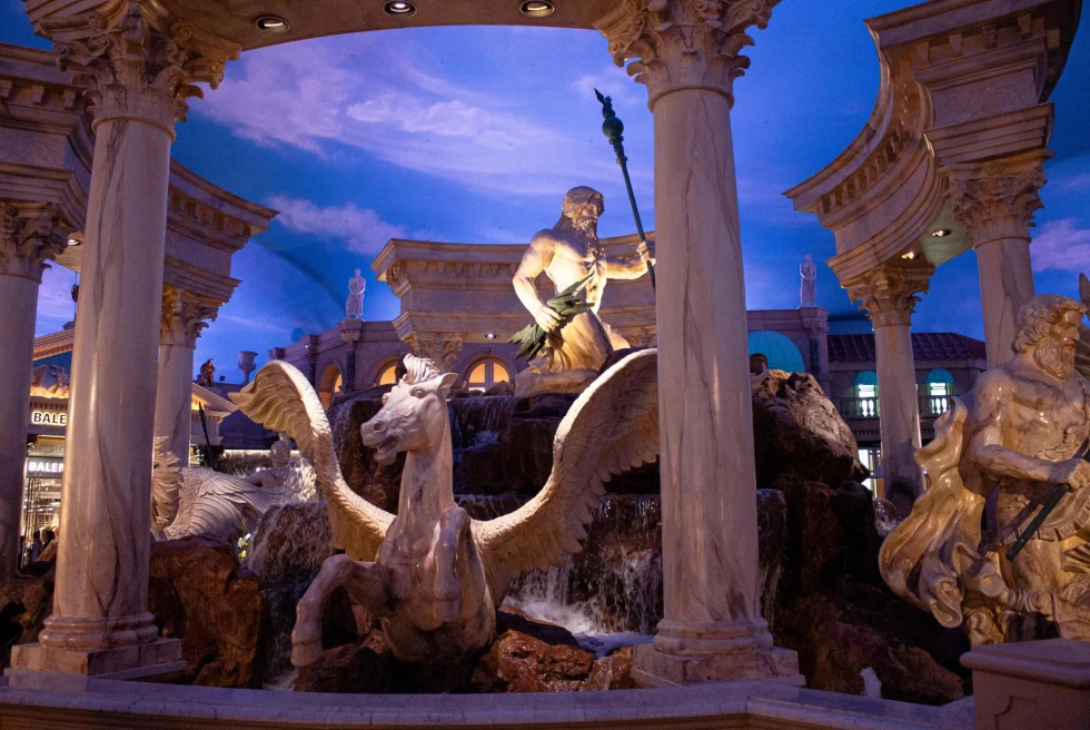 Fake Roman fountain inside hotel with painted sky ceiling.
