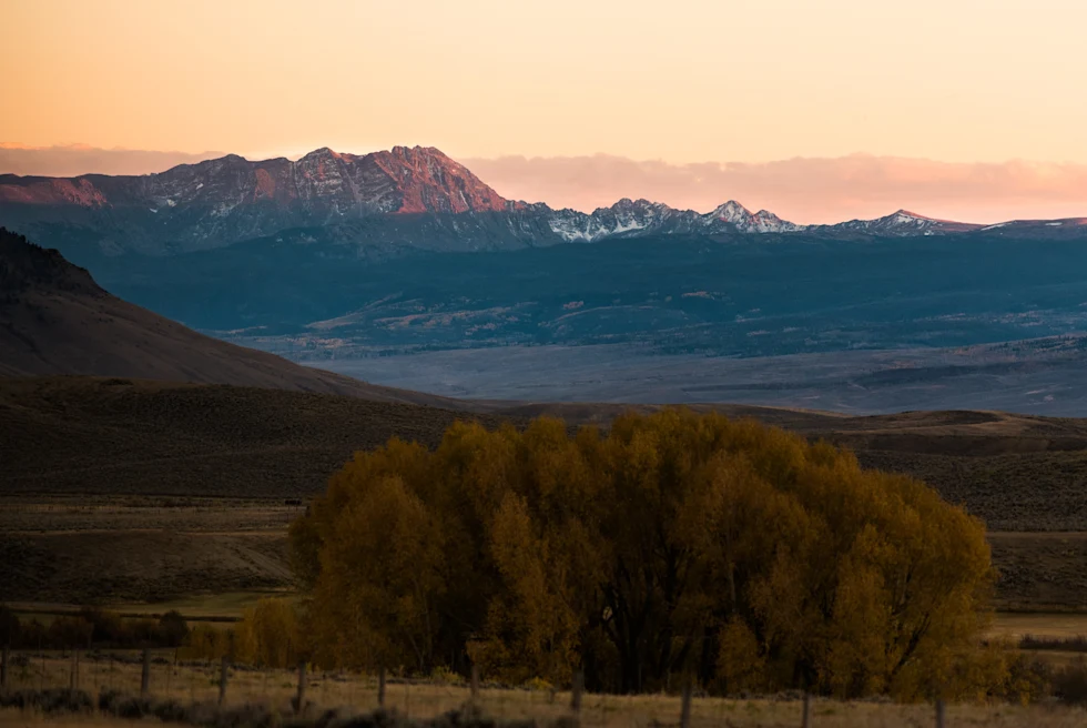 field and mountains during sunset