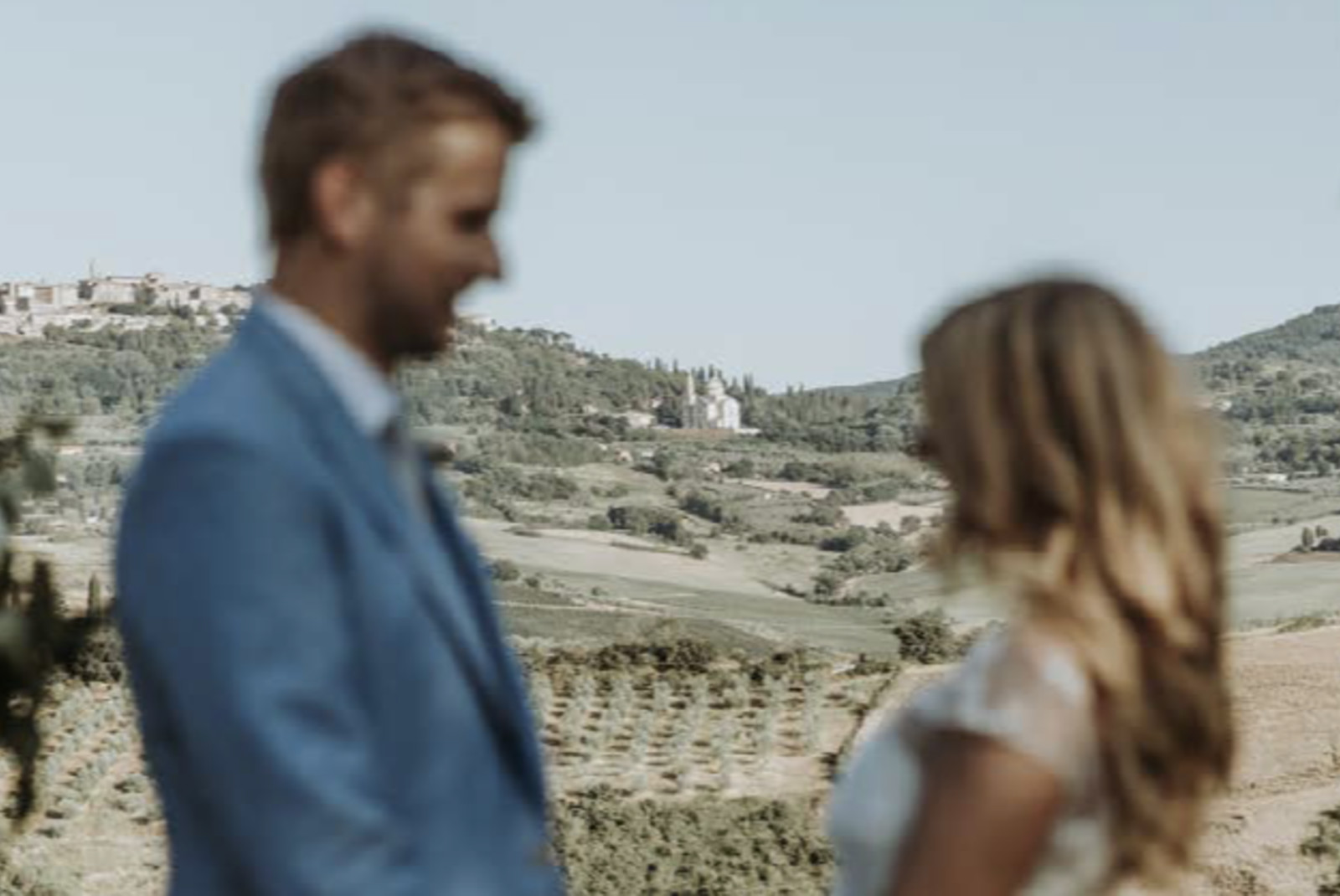 Man and woman holding hands with mountainside in the background during daytime