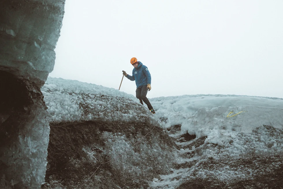 A person climbing up the snowy mountain