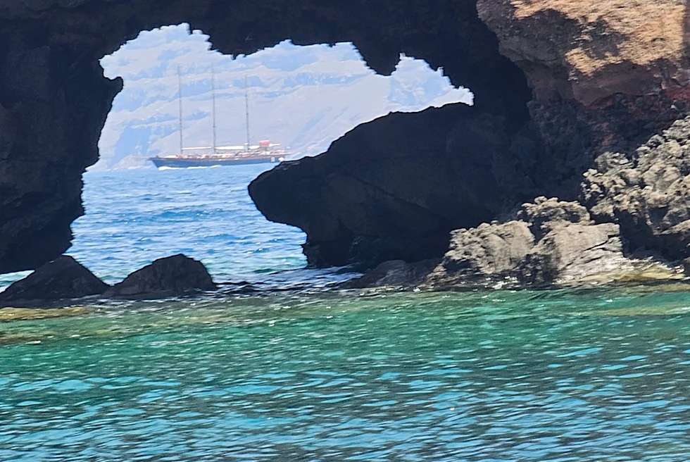 large boat through cave in the ocean