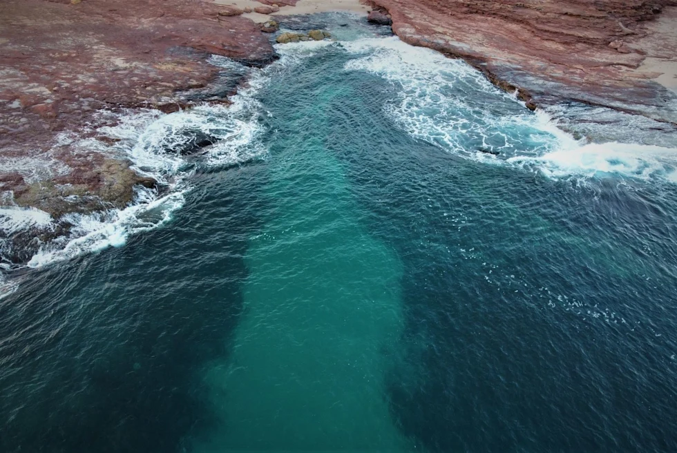 Water on a rocky beach.