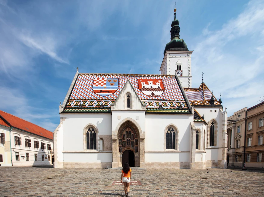 Girl walking towards a Croatian church. 