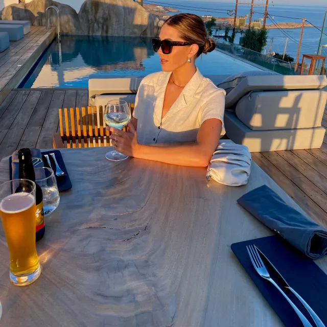 Travel advisor posing on a beachside restaurant