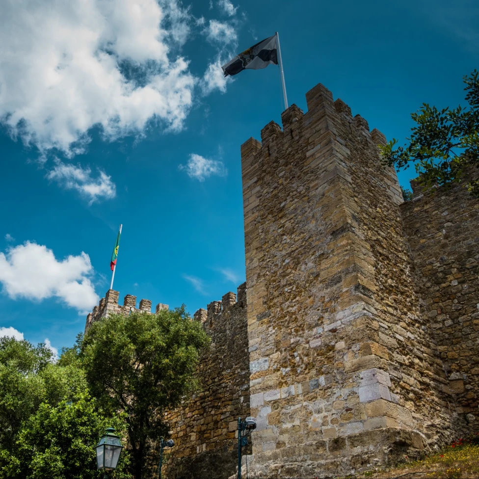 A low angle view of the outside of a castle during the daytime.