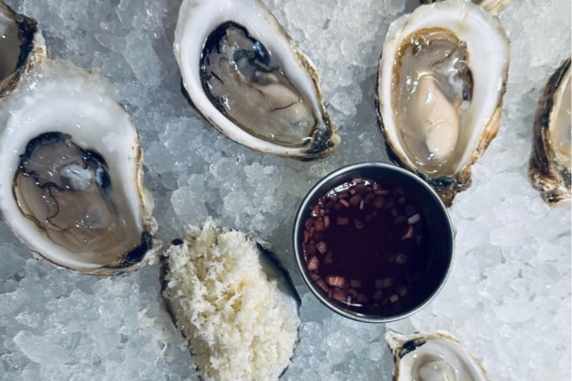 Oysters served on ice with dips.