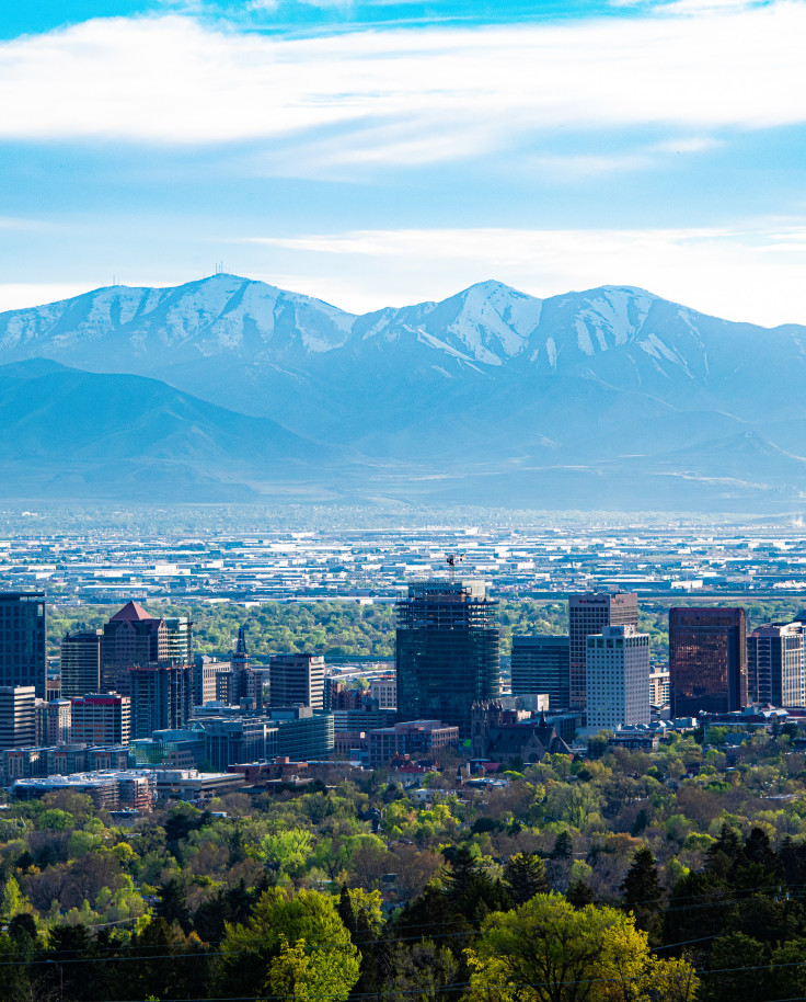 city skyline with mountains in the background during daytime