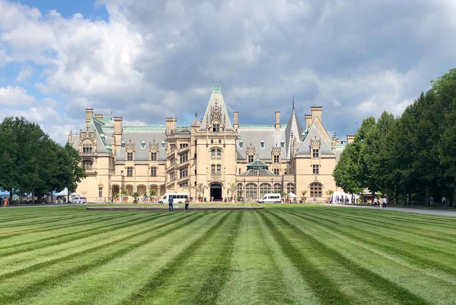 large white building with green lawn during daytime