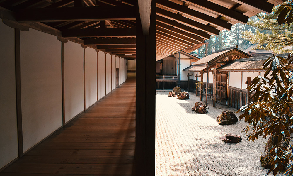 Japanese zen garden with white walls and wooden floors