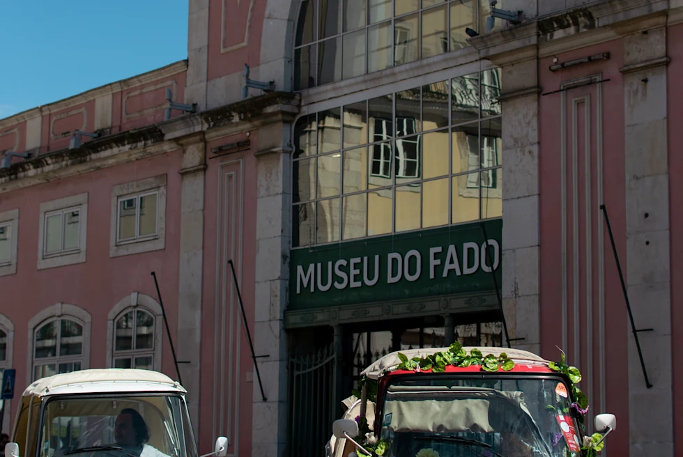 Two cars on the street in front of brick building during daytime