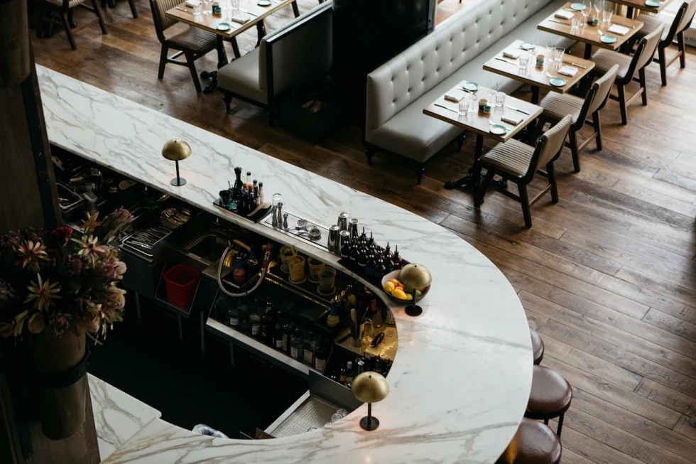aerial view of a marble bar in a sleek restaurant
