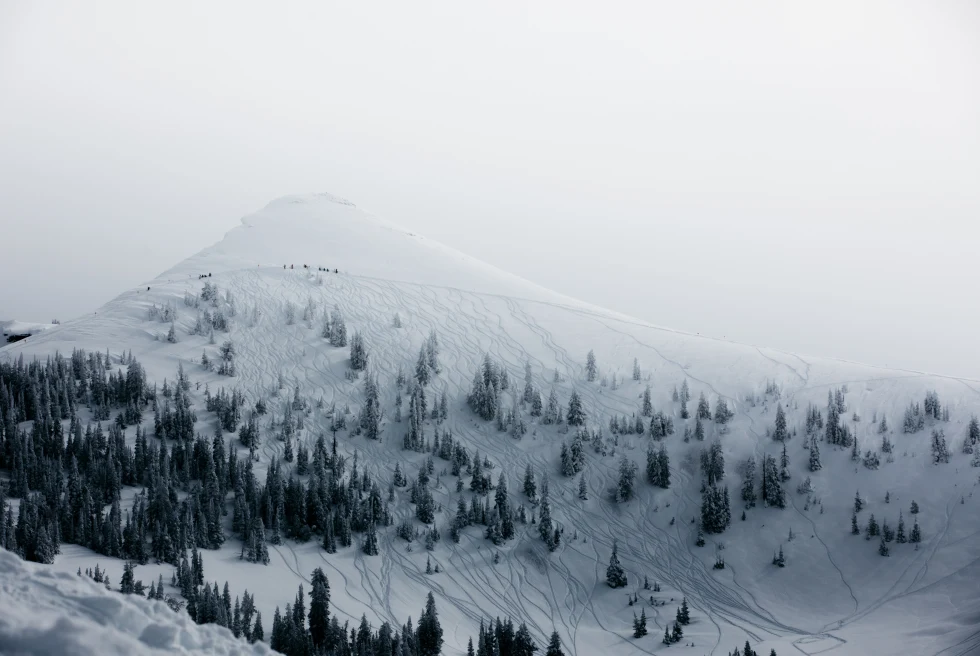 snow-covered mountain with cloudy skies