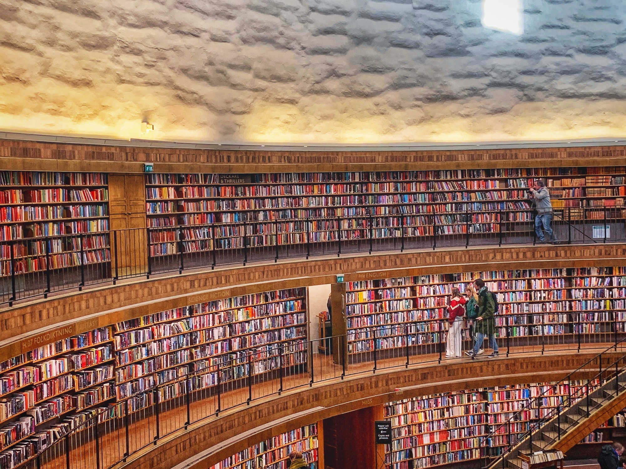 The inside of a large, curved library.