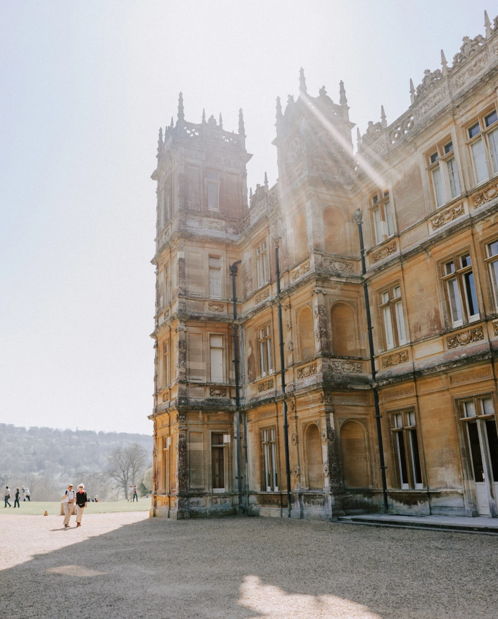 Highclere Castle is a stately English country house showcasing historical grandeur and elegance.