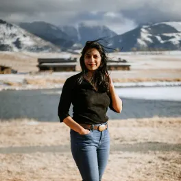 Woman standing in front of Montana mountains
