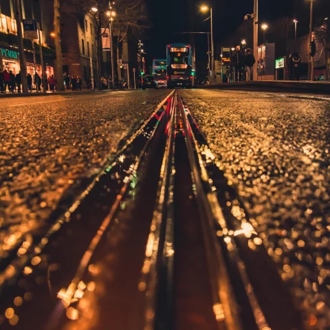 Low angle photo of railway track on road at night. 