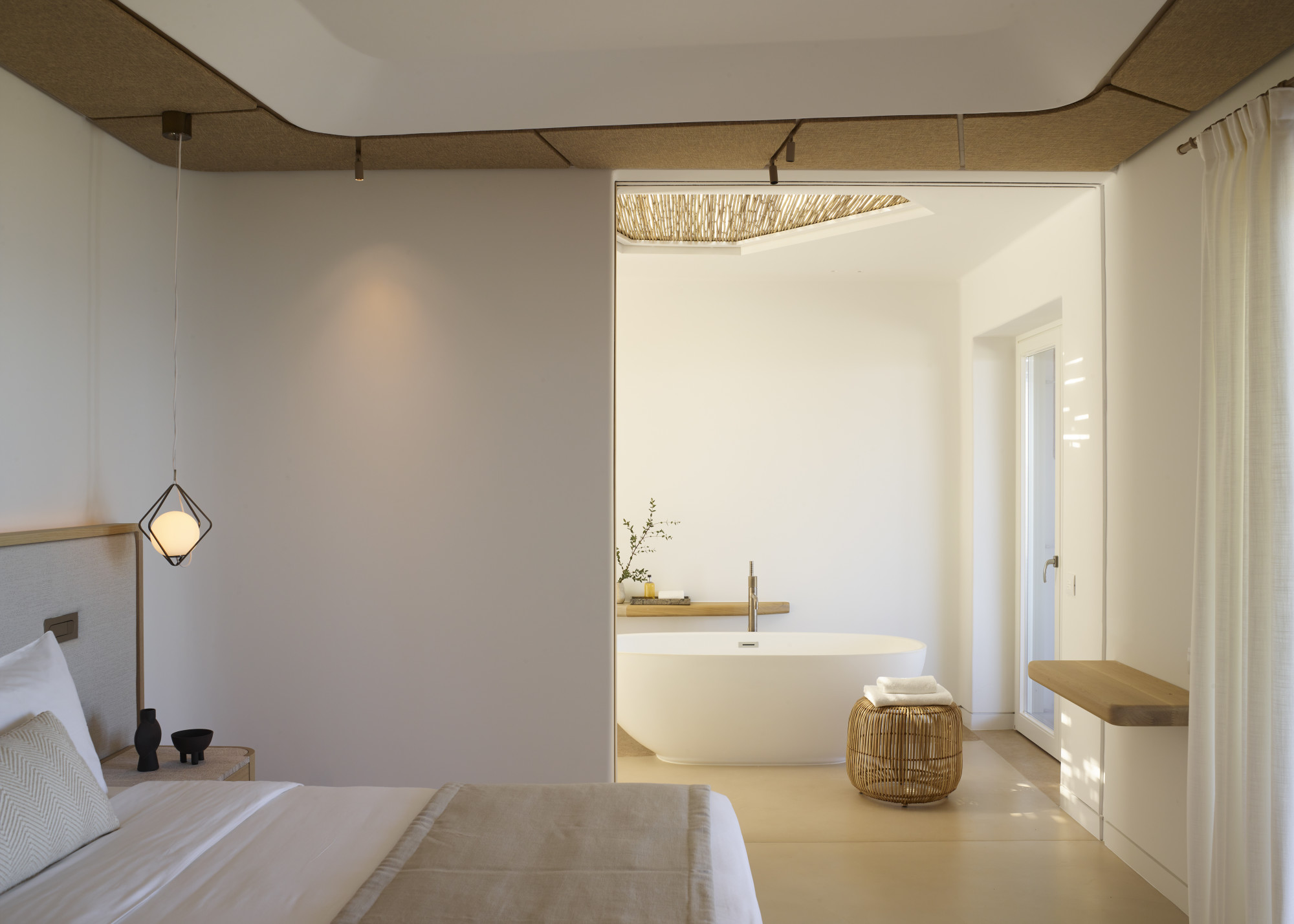 a stylish minimalist bedroom with a big modern bathtub