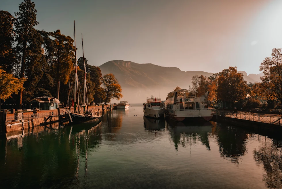 boats in water with mountains in the background