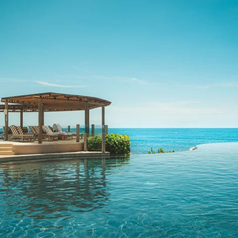 pool with a gazebo overlooking the ocean