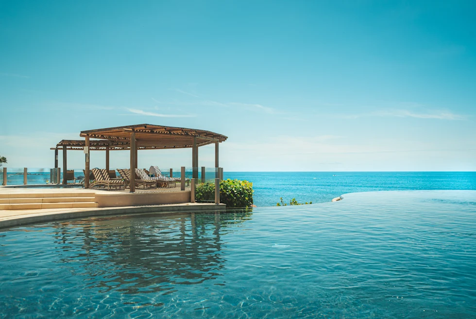 pool with a gazebo overlooking the ocean