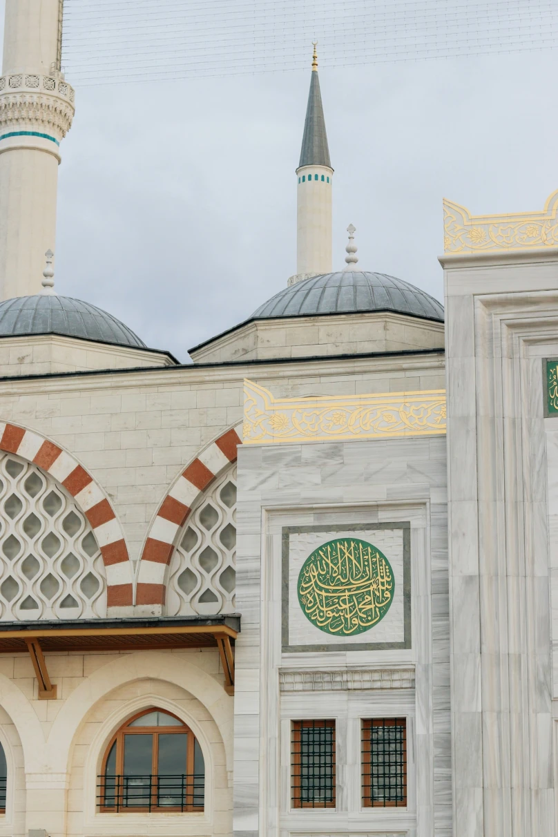 A picture of a colored Mosque with Arabic calligraphy on it.