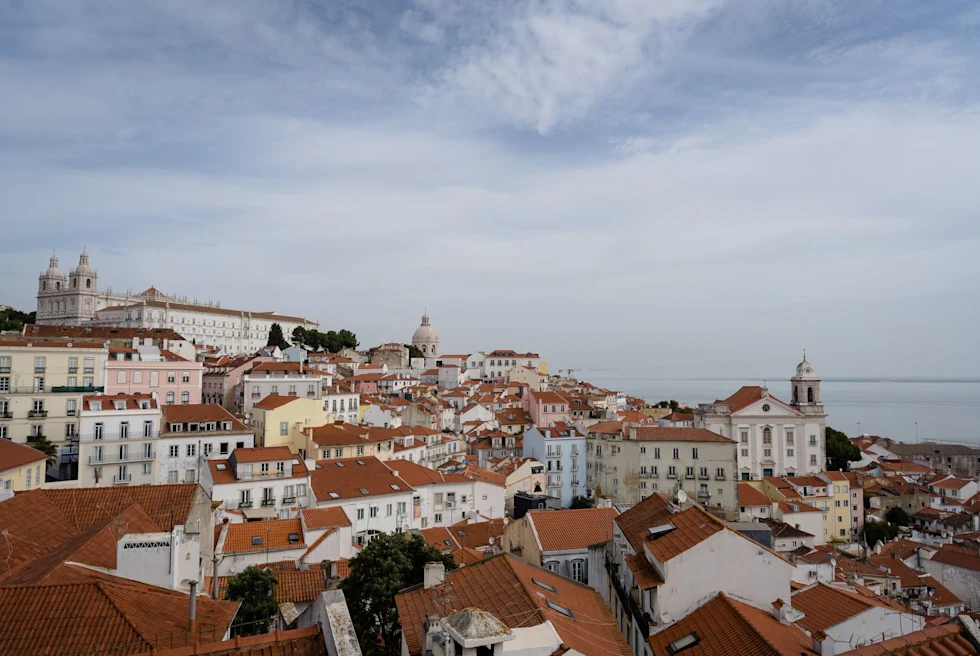 orange rooftops of a dense old city on the ocean