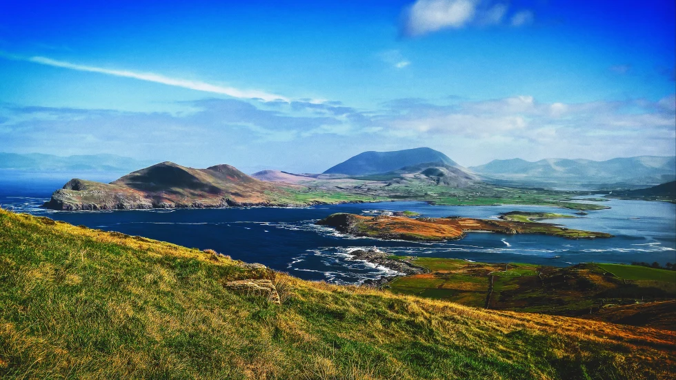 Panoramic views of hills in Ireland and water. 