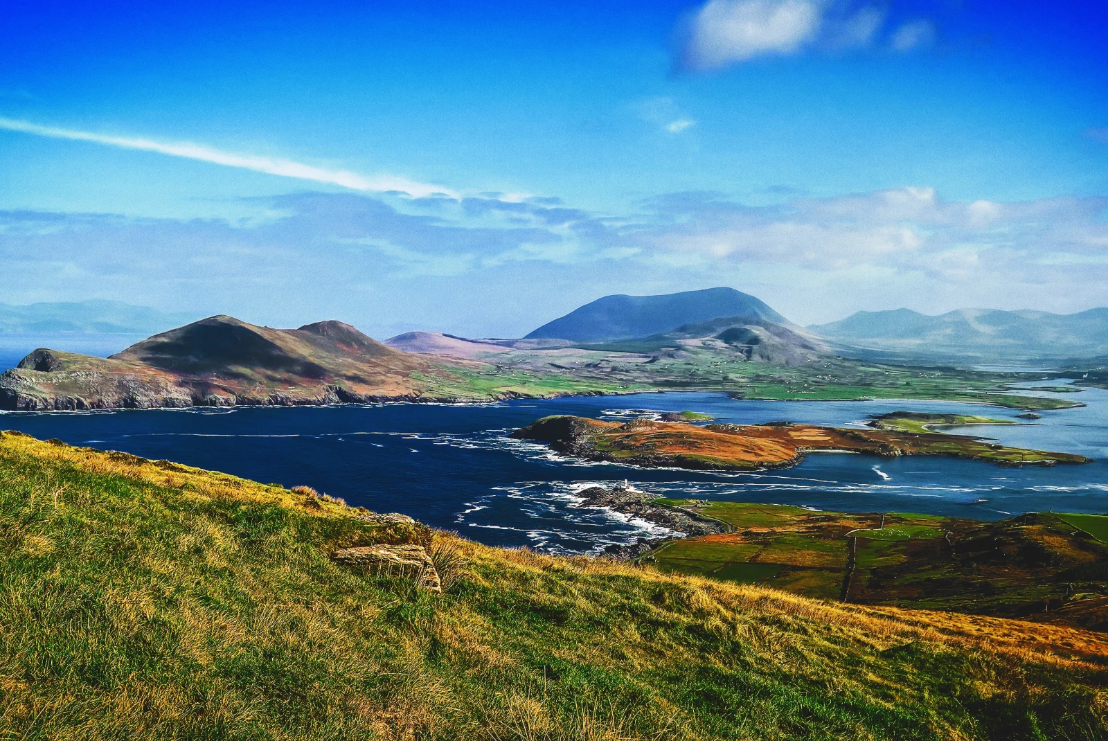 Panoramic views of hills in Ireland and water. 