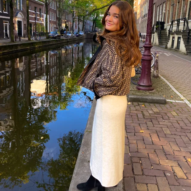 Travel advisor Grace Parry posing on the bank of a canal with hands in jacket's pockets.